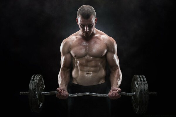 Cute young man with a barbell