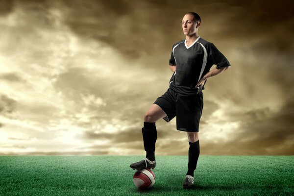 A football player stands on the field with a ball