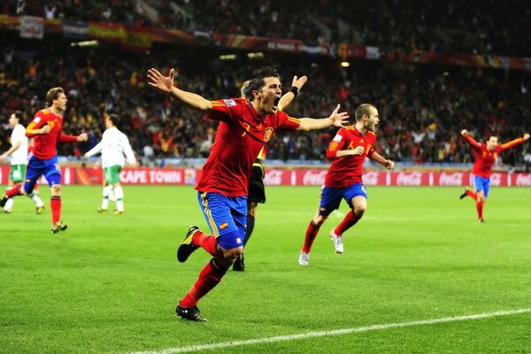 Joyful football players who scored a goal at the match