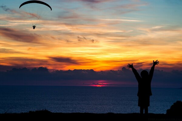 Waiting for a parent near the ocean at sunset