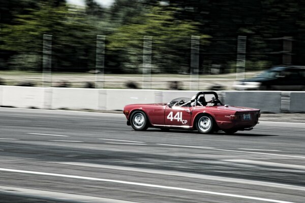 A sports car is racing on the highway