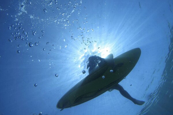 A man on a surfboard looking out of the water