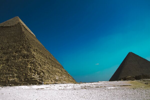 Pyramids in the desert against the blue sky