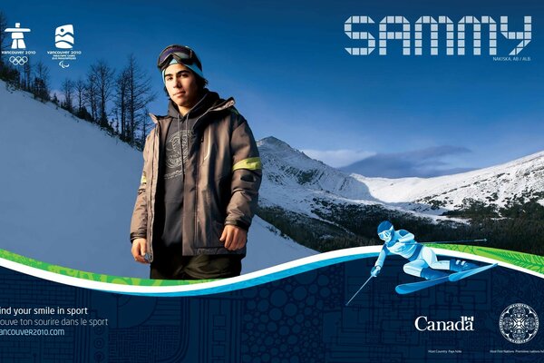 A man stands against the background of snow-capped mountains