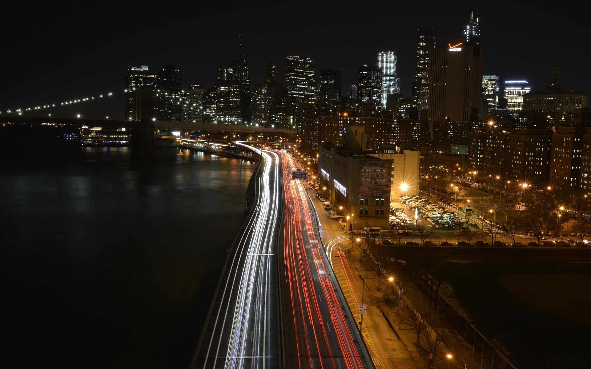 america city bridge road downtown highway traffic dusk evening urban travel cityscape building skyscraper street transportation system blur light architecture river car