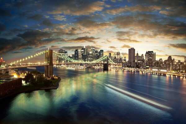 Megapolis at night. Bridge over the river