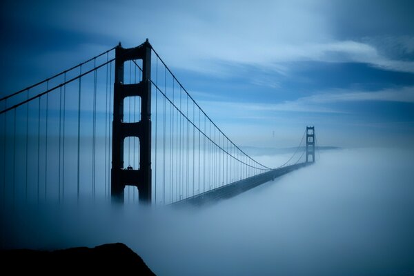 A long bridge in a thick fog