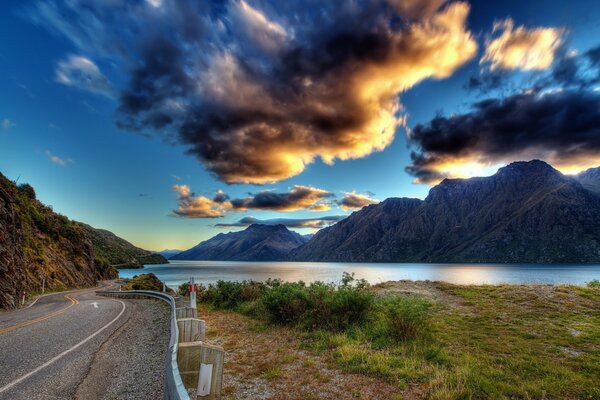 Landscape with a road on the shore of a mountain lake