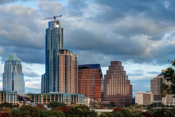 The skyscrapers of the business district rest against the clouds