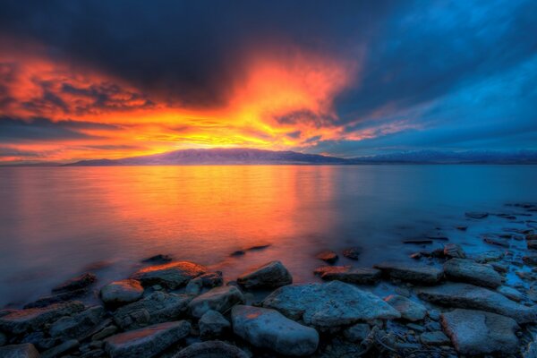 Orange sunset on the surface of the sea coast