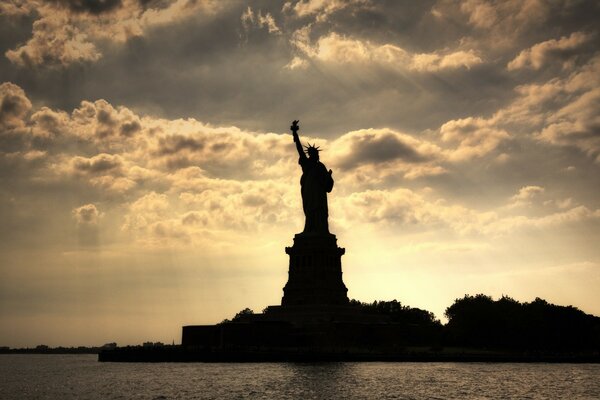 Statue of Liberty at sunrise in the waters of New York Harbor