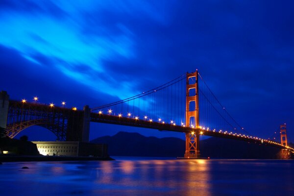 Suspension bridge illuminated by lanterns