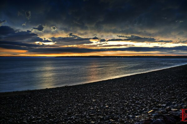 Low sunset over the deserted shore of the lake