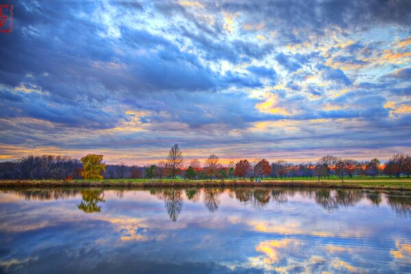 Der Sonnenuntergang spiegelt sich im Fluss regenbogenfarben wider