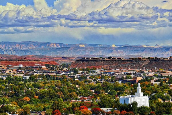 A picturesque town with a white church is spread out in a valley