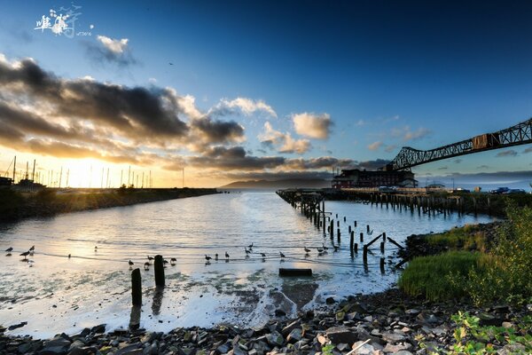 Pier in the rays of the dawn sun