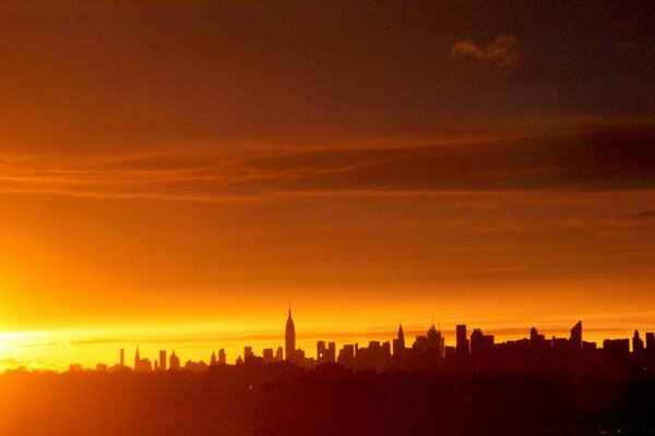 Silhouette sombre de la ville au coucher du soleil