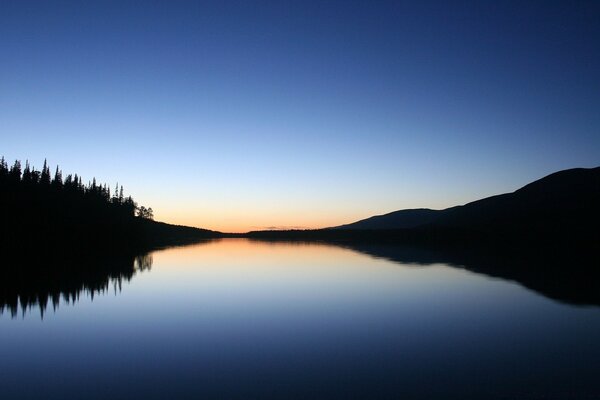 Sunset over the water sky and water in one tone