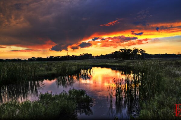 The sunset sky is reflected in the river