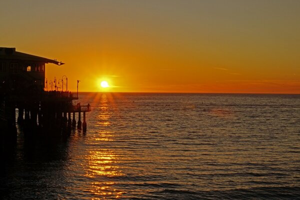 Sunset on the background of the pier