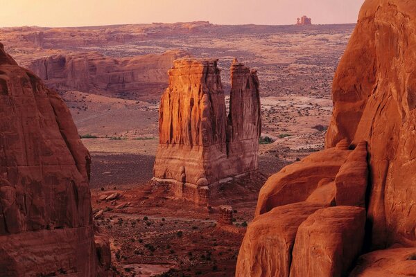 A lonely rock in the middle of a canyon in the desert