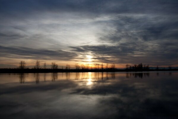 Cloudy dawn over a large lake