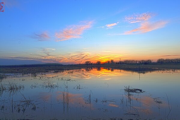 Reflection of the sunset in the water space