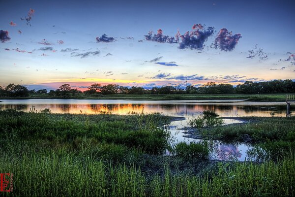 Morning dawn on the background of the lake