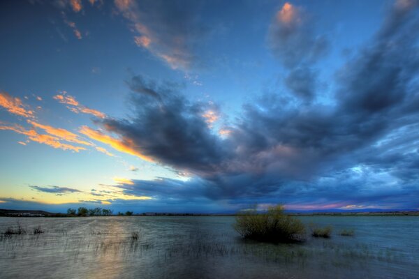 Cumulus sunset clouds over the surface of the lake