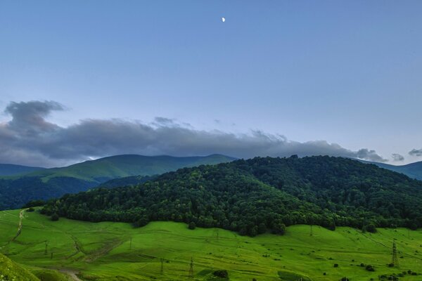 Emerald hill with clouds on top