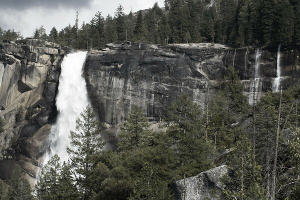 Mountain waterfall. The unconquered energy of nature