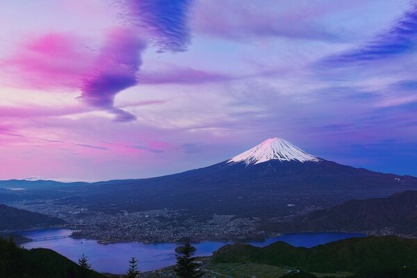 Volcano in Asia at sunset with a snow cap trail