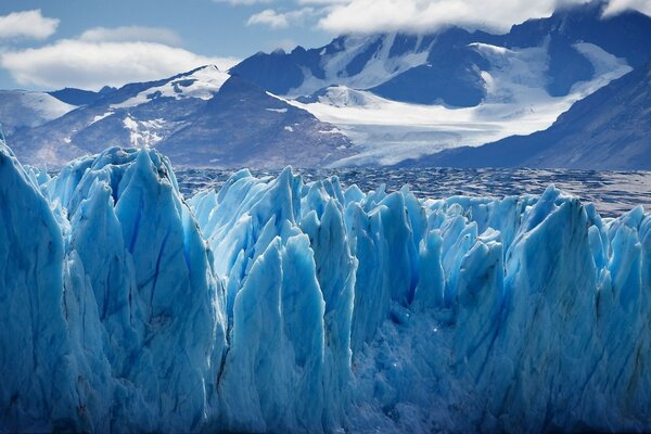 Glaciers are blue in Antarctica against the background of mountains