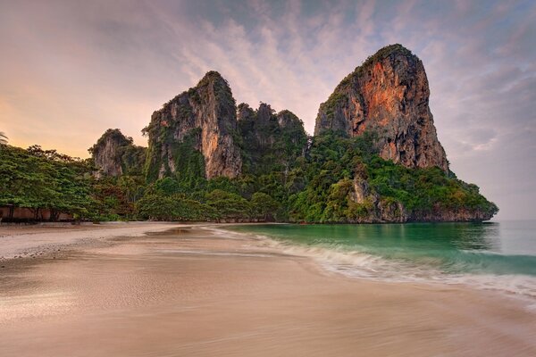 Turquoise waves on a sandy beach