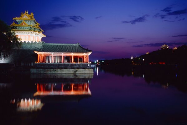 Pagoda on the river bank at night