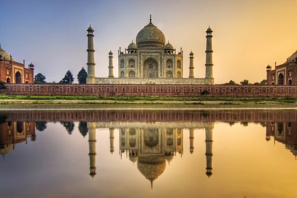 A religious building is reflected in the water