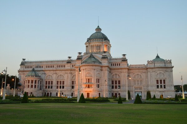 A majestic building on a green lawn