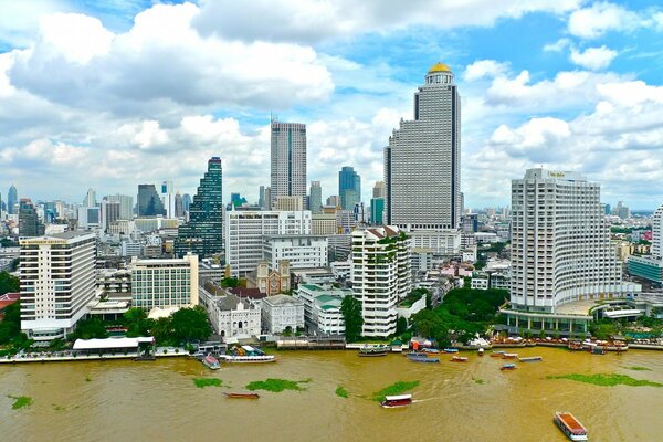 Dirty sea on the background of beautiful skyscrapers