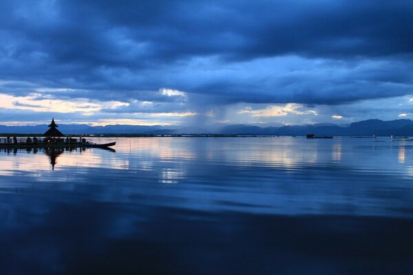 The cloudy evening sky is reflected in the water