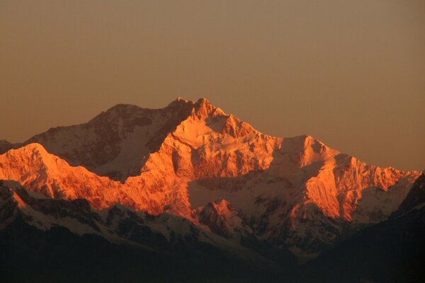 Verrostete schneebedeckte Berge im Licht der Sonnenstrahlen