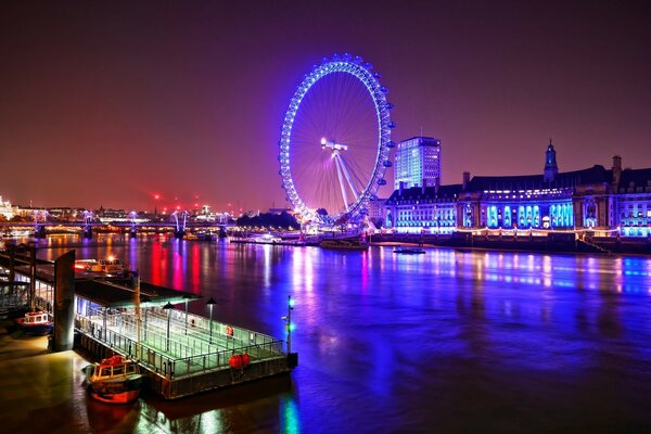 Evening city with a view of the Ferris wheel