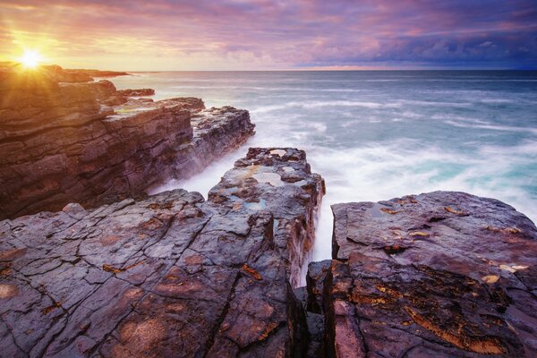 View from the cliff into the sea at sunrise