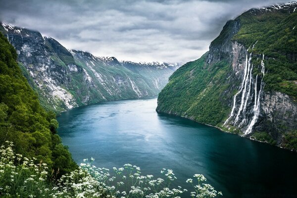 A wide river flows between the mountains