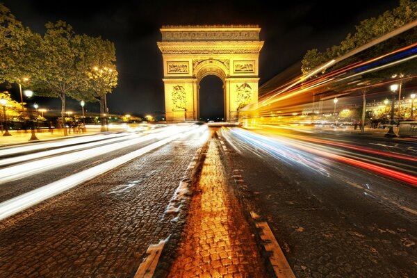 Arch in Paris on the road in the night city