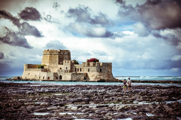 A castle in the middle of stones water and sky