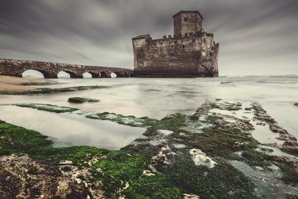 Winter landscape of a tower with a bridge