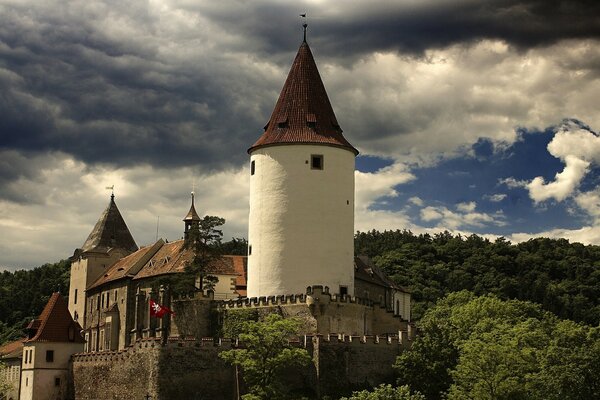 Tower on the background of forest and clouds