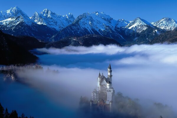 Mittelalterliche Burg in den Bergen unter den Wolken