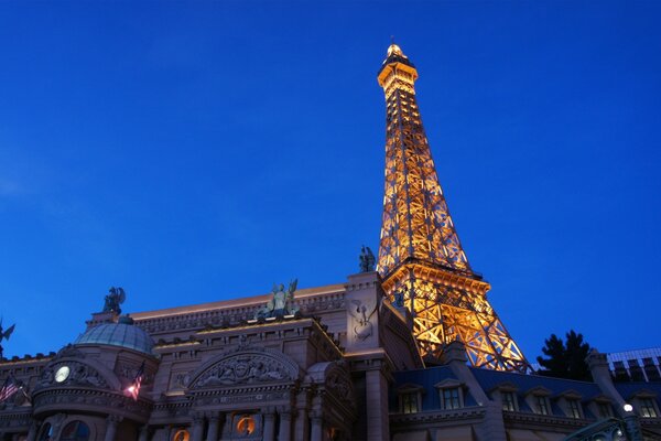 Illuminated Eiffel Tower against the background of the evening sky