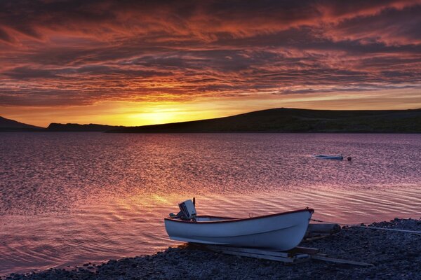 Pre-dawn clouds over the water and boats